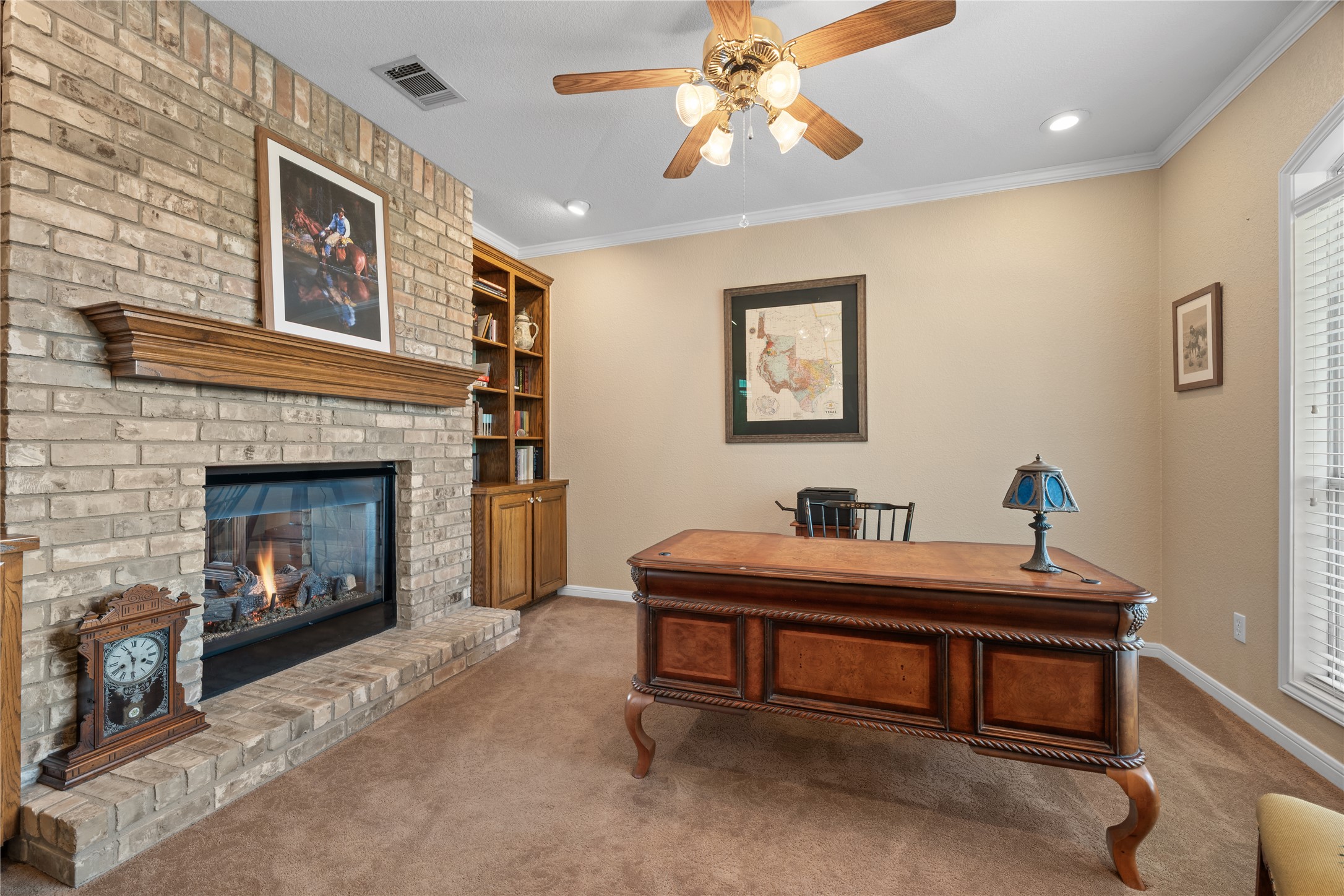 266 Courtnee's Way Georgetown, TX 78626 - Photo 8 of 40 Brick fireplace with a wood mantle and hearth. Built-in custom bookcases.