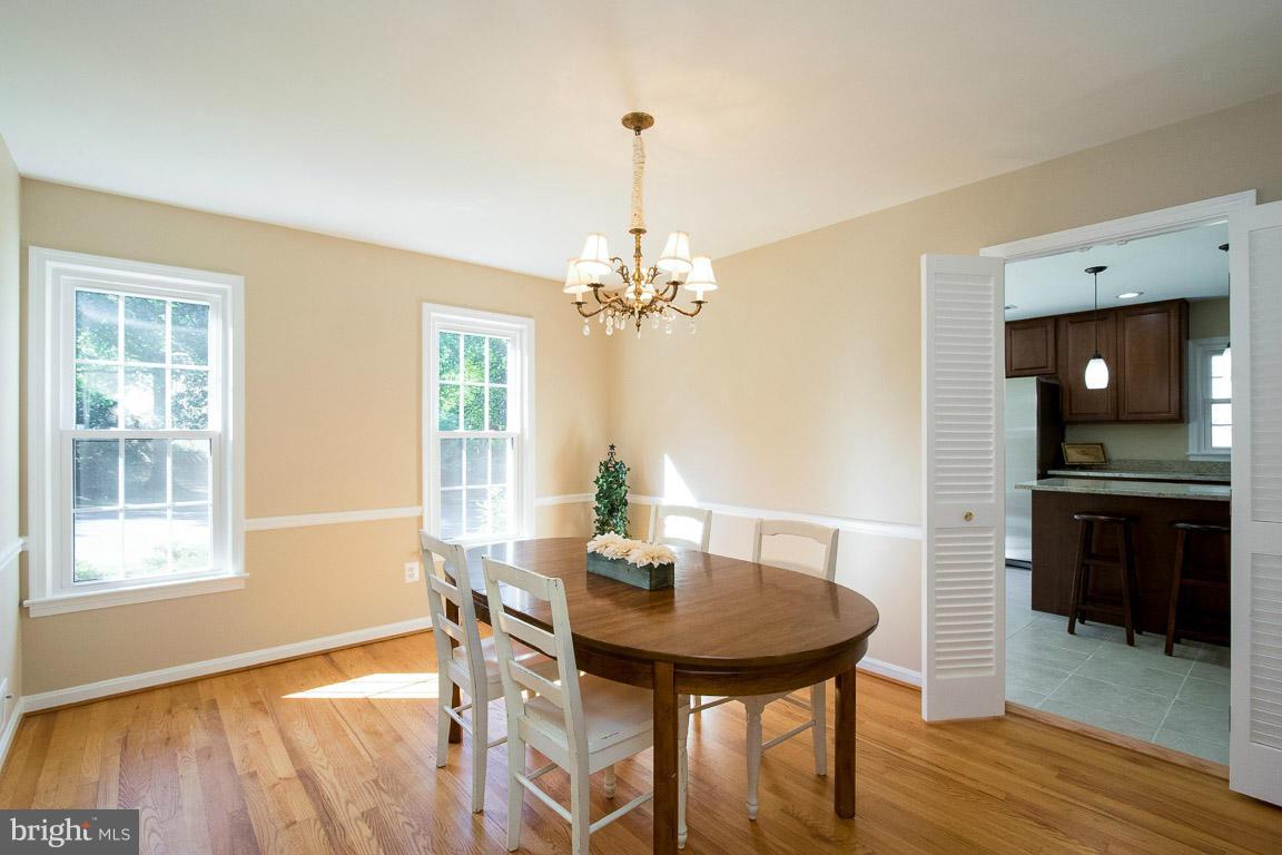 10802 Hunt Club Road Reston, VA 20190 - Photo 11 of 30 a view of a dining room with furniture window and wooden floor