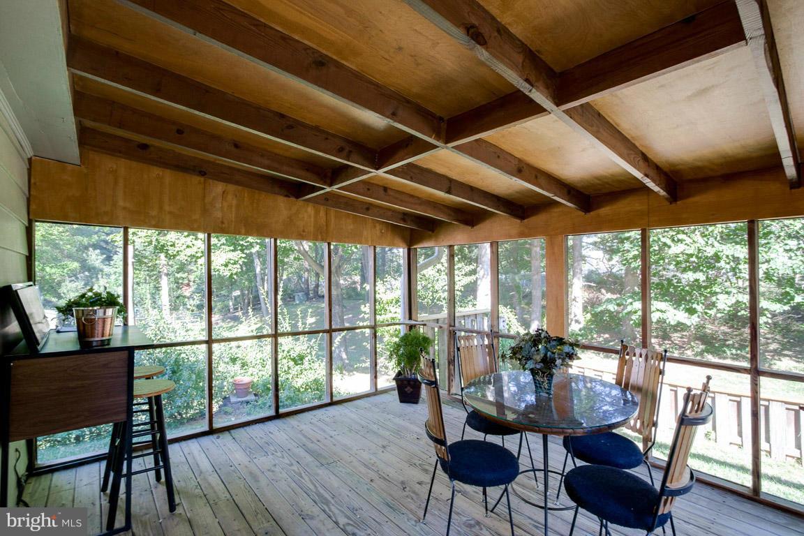 10802 Hunt Club Road Reston, VA 20190 - Photo 15 of 30 a dining room with furniture wooden floor and a potted plant