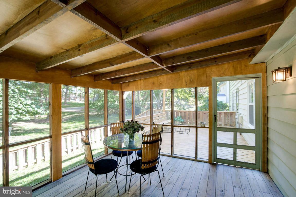 10802 Hunt Club Road Reston, VA 20190 - Photo 16 of 30 a dining room with furniture and wooden floor
