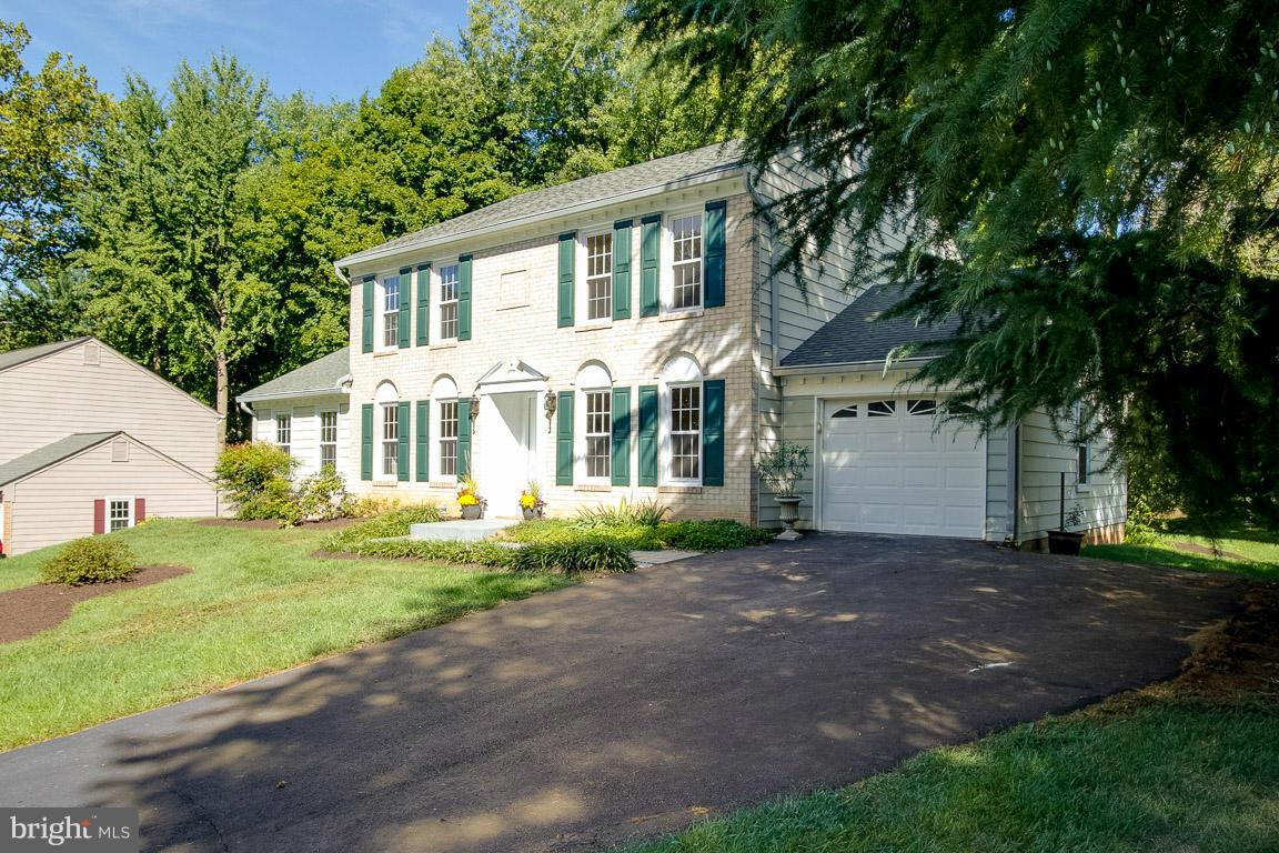 10802 Hunt Club Road Reston, VA 20190 - Photo 3 of 30 a front view of a house with a yard and garage