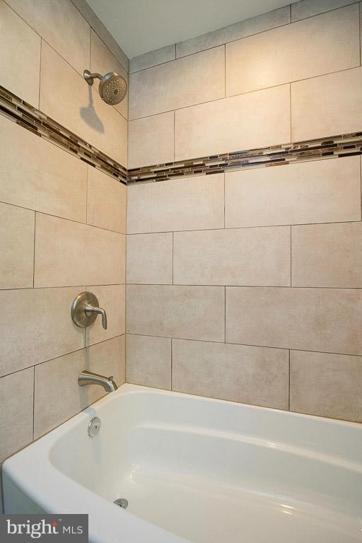 10802 Hunt Club Road Reston, VA 20190 - Photo 25 of 30 a bathroom with a bathtub and a shower