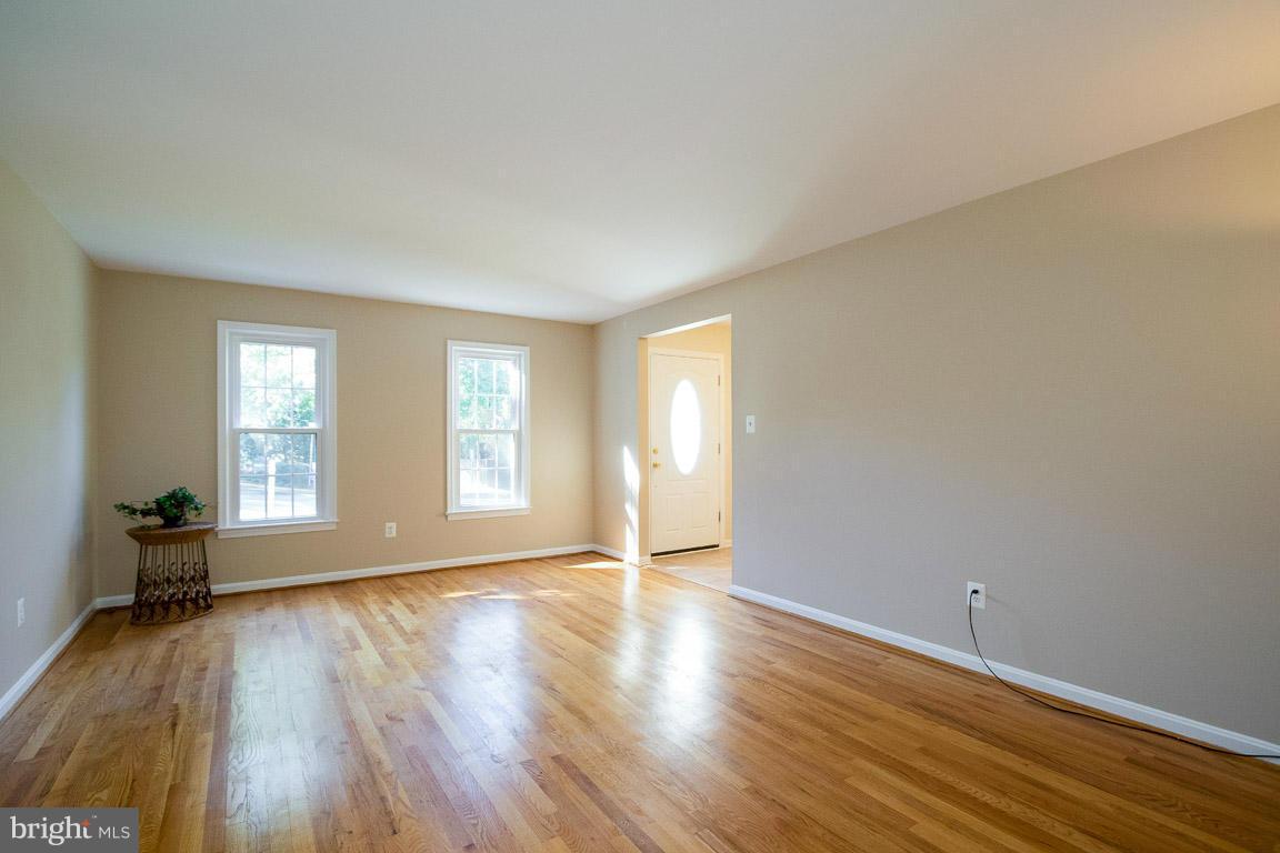 10802 Hunt Club Road Reston, VA 20190 - Photo 6 of 30 a view of an empty room with wooden floor and a window