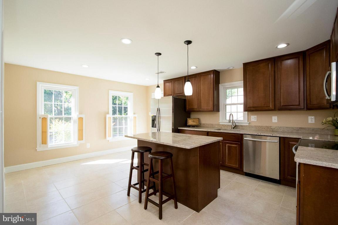 10802 Hunt Club Road Reston, VA 20190 - Photo 8 of 30 a kitchen with a sink a window and chairs