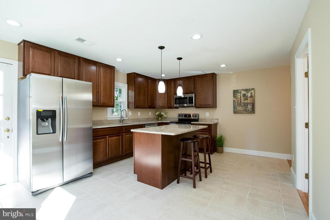 10802 Hunt Club Road Reston, VA 20190 - Photo 9 of 30 a kitchen with a refrigerator a sink and a microwave