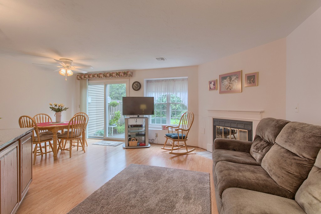 914 Ridgefield Circle, Unit B Clinton, MA 01510 - Photo 11 of 30 a living room with furniture a fireplace and a flat screen tv