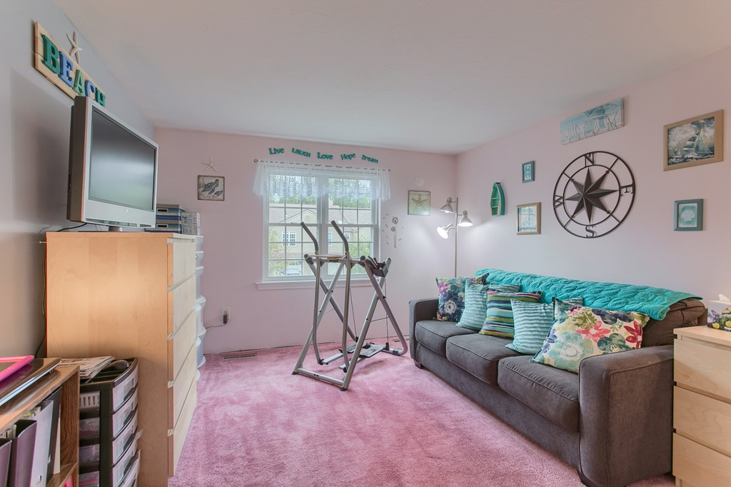 914 Ridgefield Circle, Unit B Clinton, MA 01510 - Photo 16 of 30 a living room with furniture and a flat screen tv