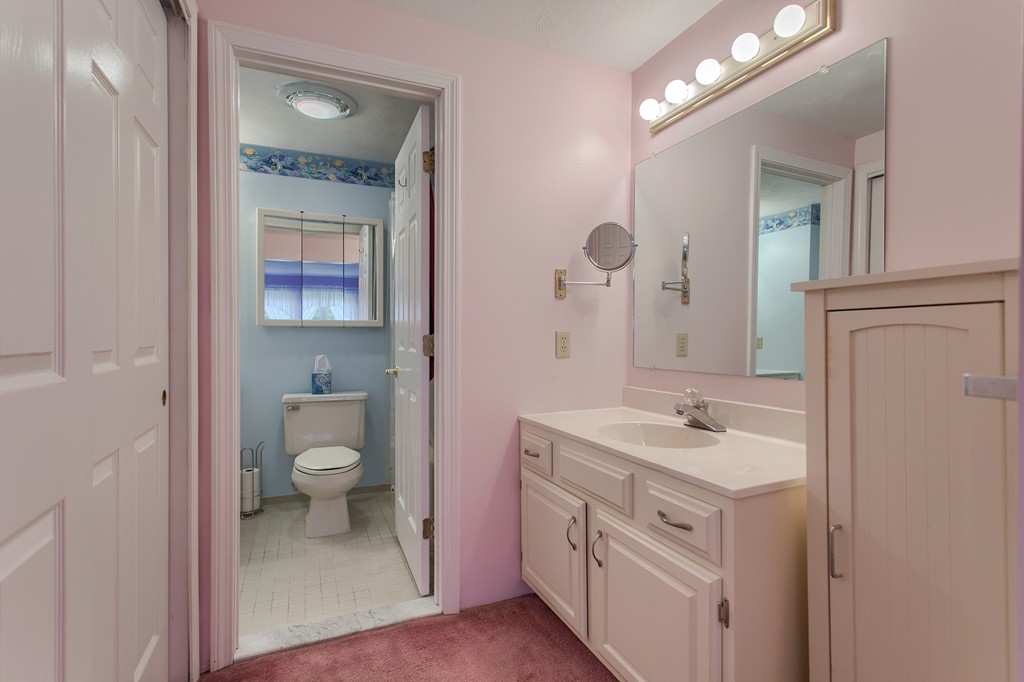 914 Ridgefield Circle, Unit B Clinton, MA 01510 - Photo 21 of 30 a bathroom with a sink a toilet and a mirror