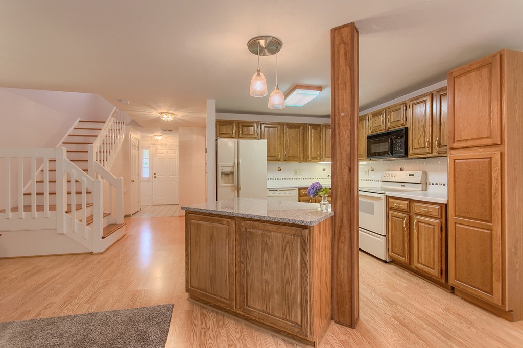 914 Ridgefield Circle, Unit B Clinton, MA 01510 - Photo 3 of 30 a kitchen with cabinets and wooden floor