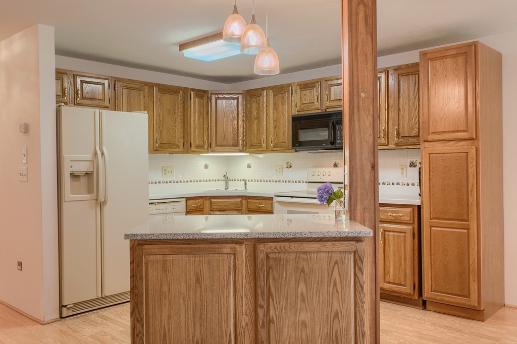 914 Ridgefield Circle, Unit B Clinton, MA 01510 - Photo 4 of 30 a kitchen with stainless steel appliances granite countertop a refrigerator and a sink