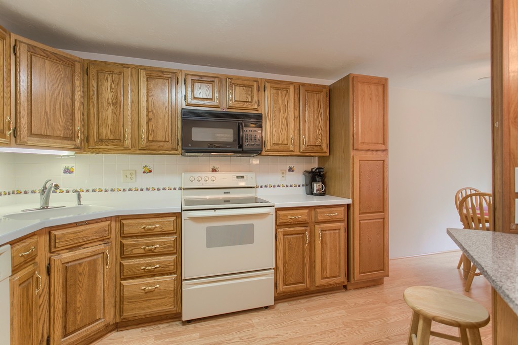 914 Ridgefield Circle, Unit B Clinton, MA 01510 - Photo 6 of 30 a kitchen with granite countertop cabinets stainless steel appliances and a sink