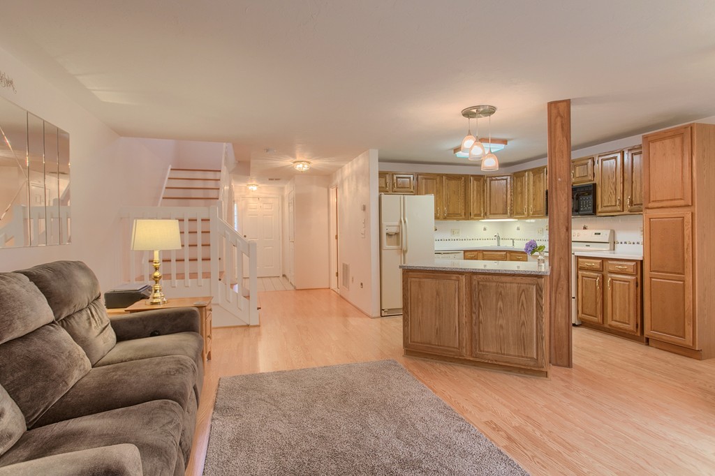 914 Ridgefield Circle, Unit B Clinton, MA 01510 - Photo 8 of 30 a living room with kitchen island furniture and a kitchen view
