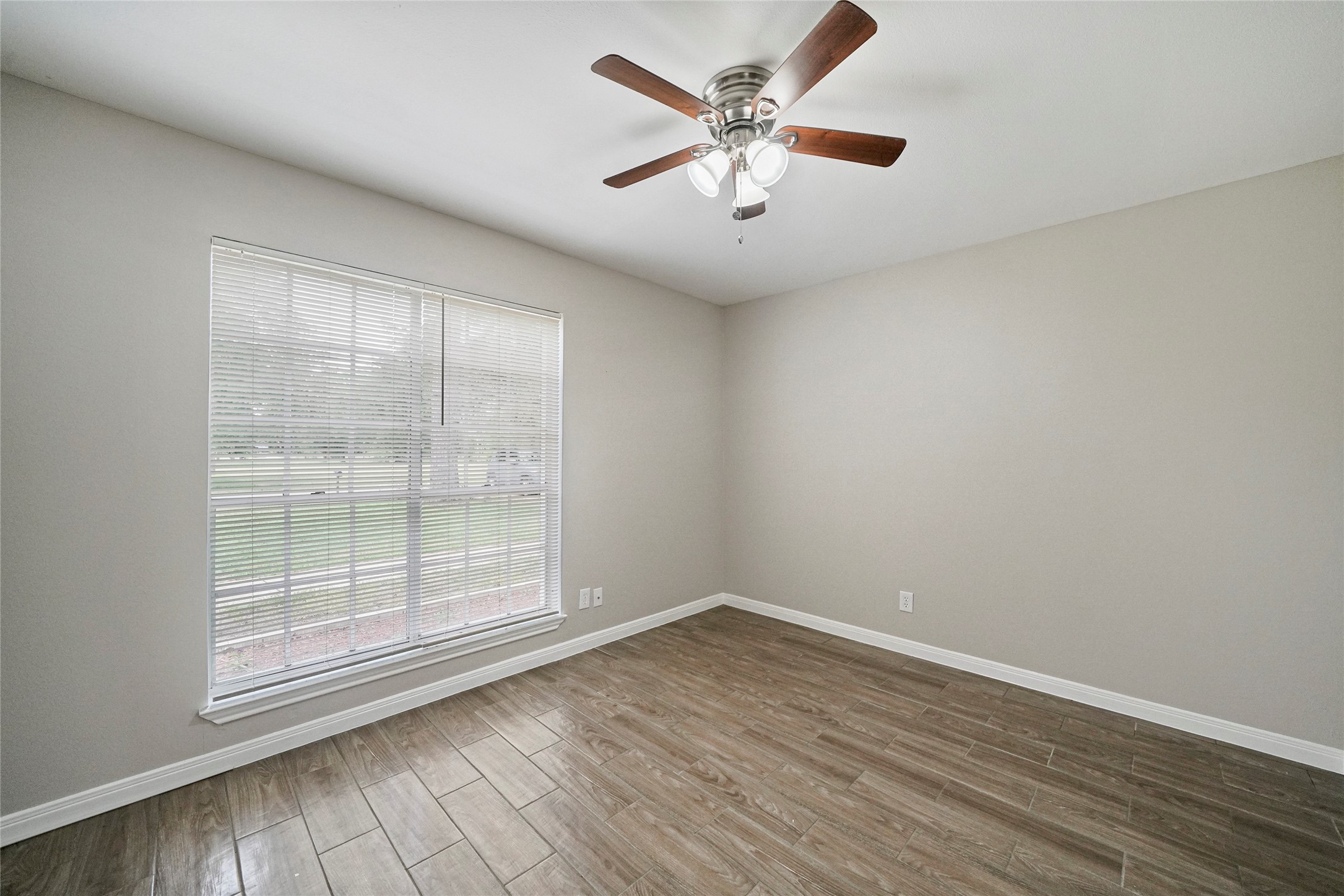 643 Ames Street Spring, TX 77373 - Photo 11 of 32 an empty room with wooden floor and windows