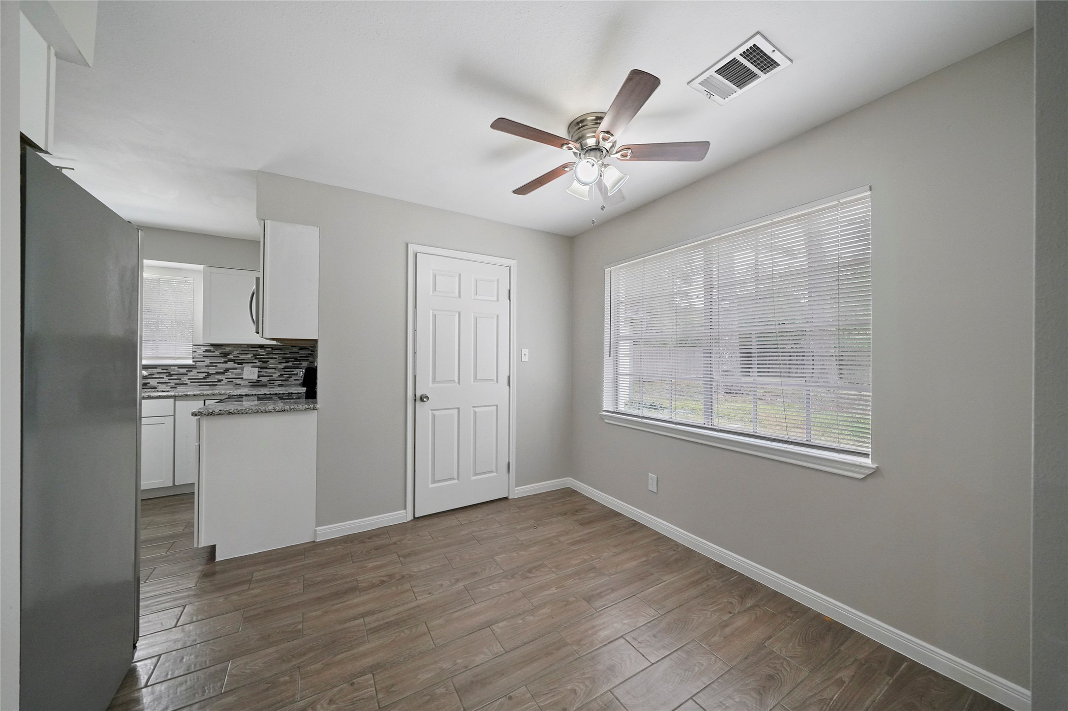 643 Ames Street Spring, TX 77373 - Photo 15 of 32 a view of an empty room with a window and wooden floor