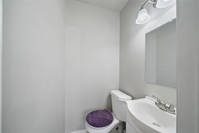 a white toilet sitting next to a bathroom sink