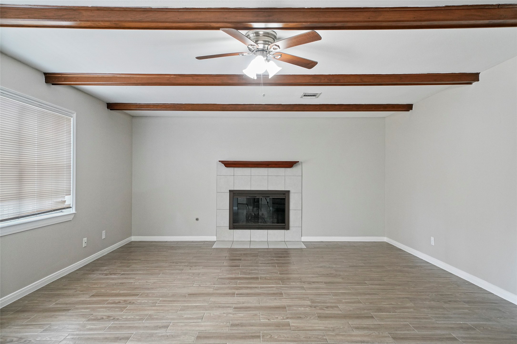 643 Ames Street Spring, TX 77373 - Photo 18 of 32 a view of an empty room with window and wooden floor