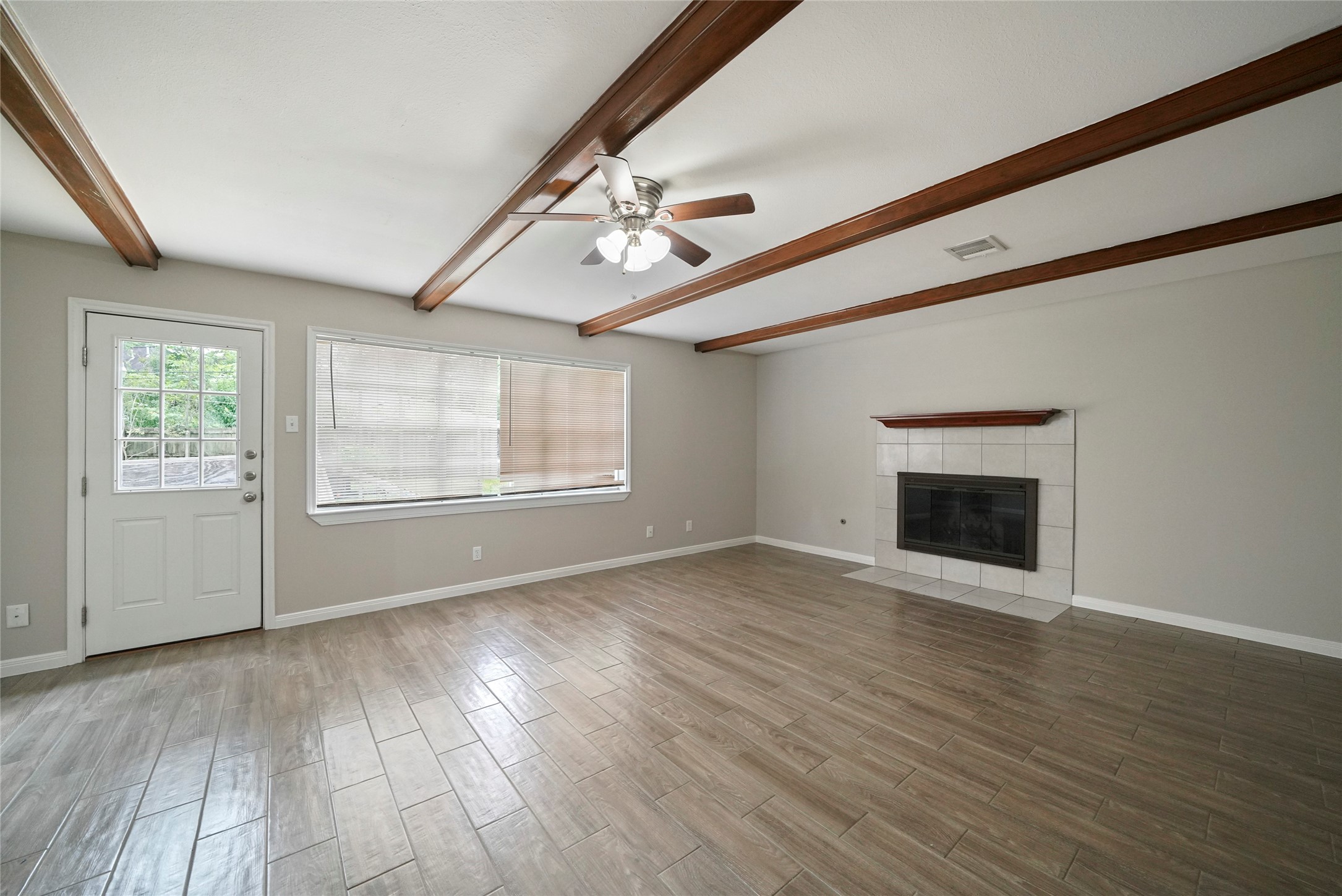 643 Ames Street Spring, TX 77373 - Photo 19 of 32 a view of an empty room with wooden floor and a window