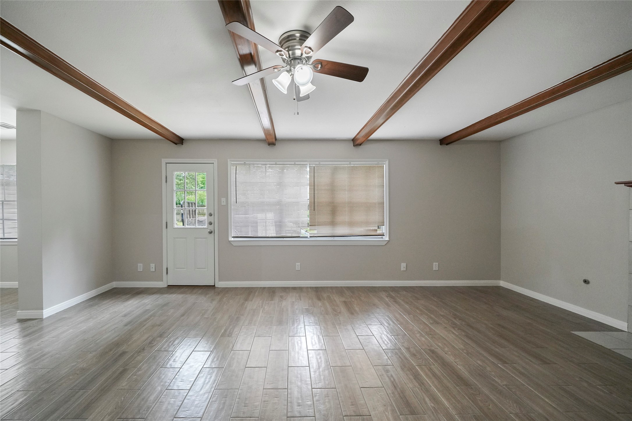 643 Ames Street Spring, TX 77373 - Photo 20 of 32 an empty room with wooden floor chandelier fan and windows