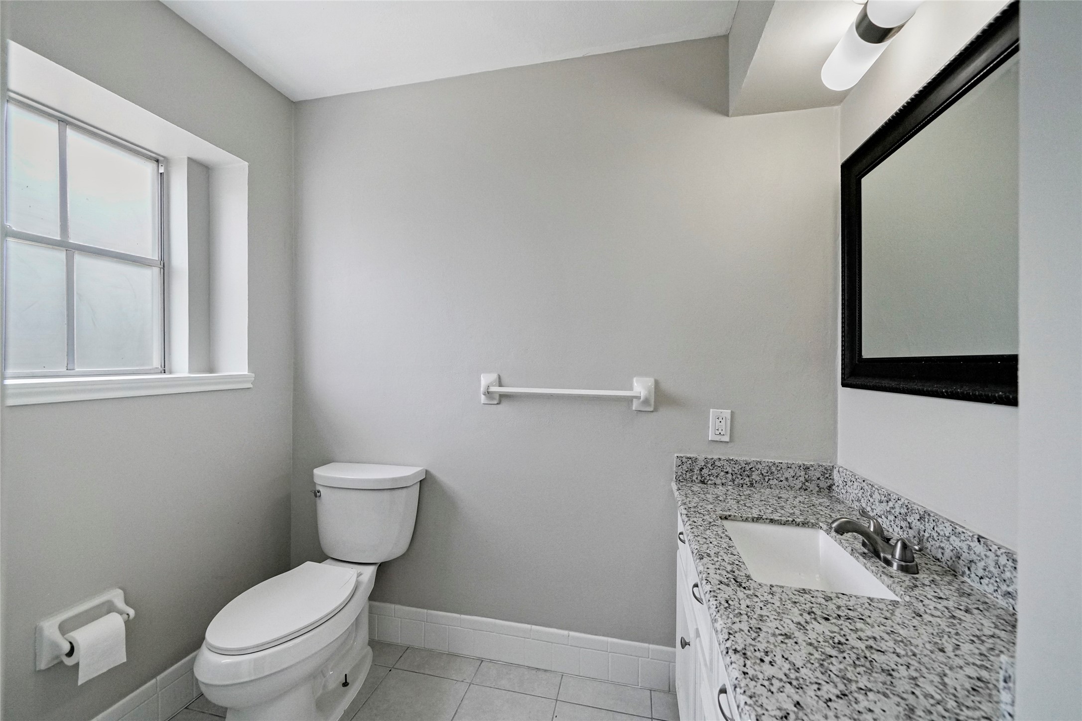 643 Ames Street Spring, TX 77373 - Photo 24 of 32 a bathroom with a granite countertop toilet and a sink