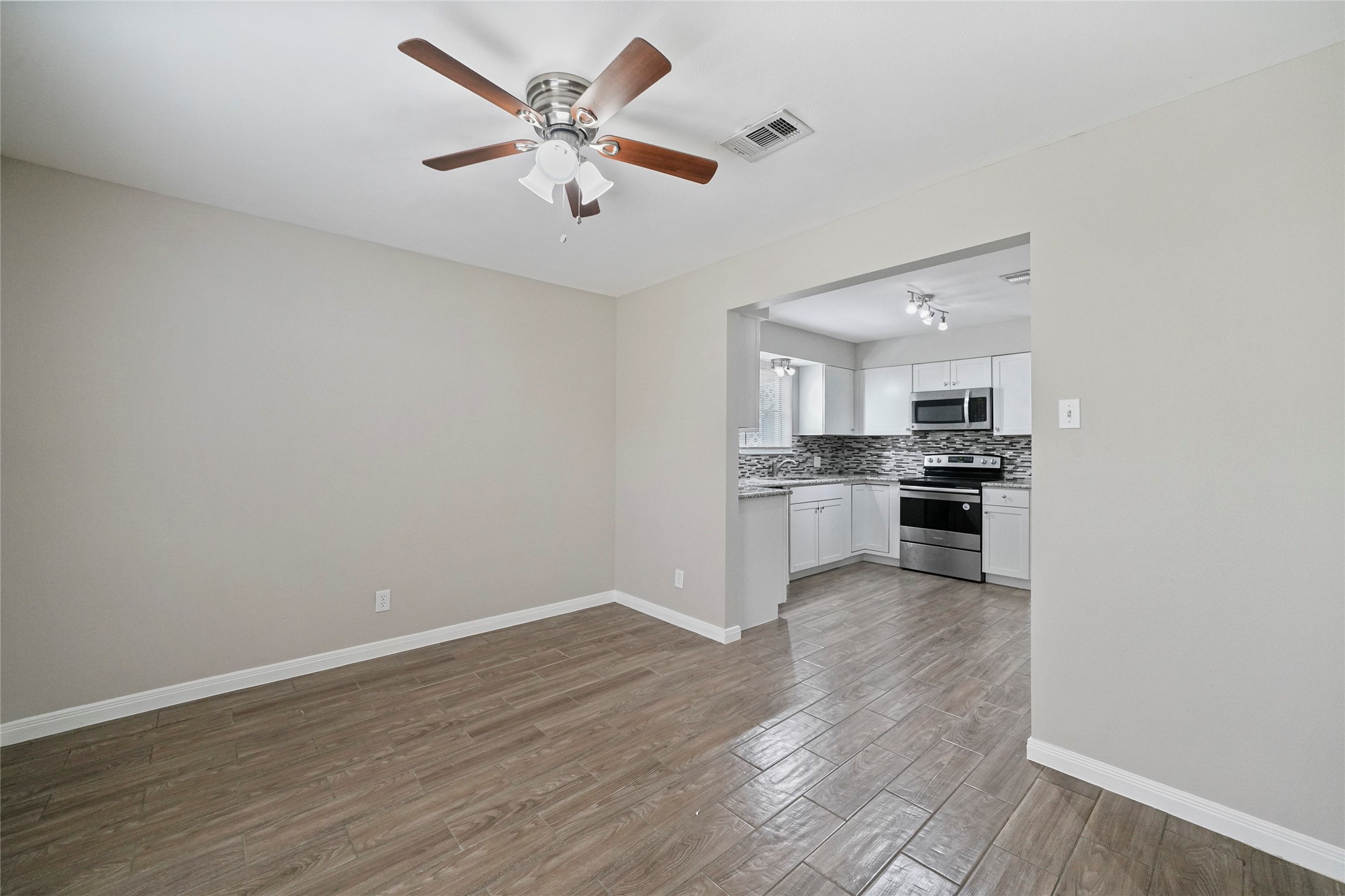643 Ames Street Spring, TX 77373 - Photo 8 of 32 a view of kitchen with granite countertop cabinets and refrigerator