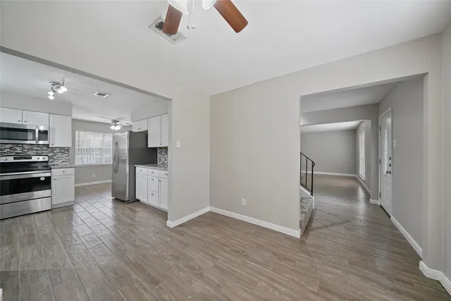 a view of kitchen with refrigerator microwave and stove