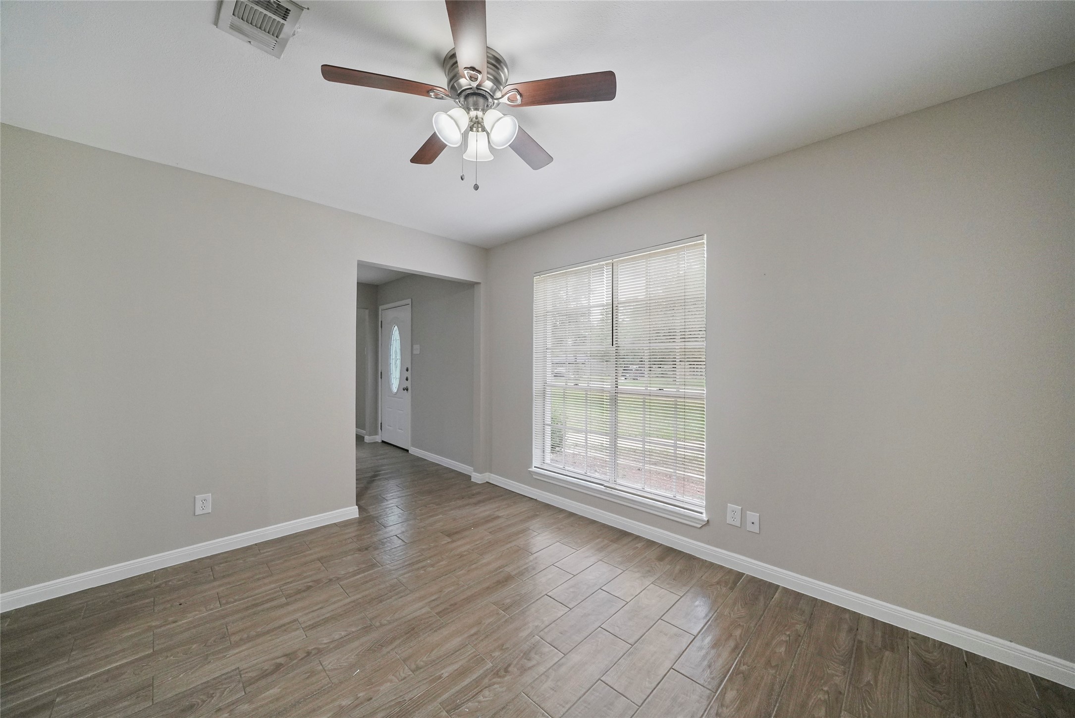 643 Ames Street Spring, TX 77373 - Photo 10 of 32 an empty room with wooden floor and windows
