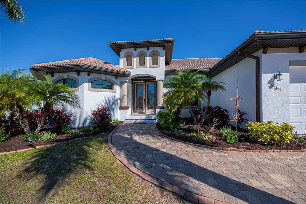1736 Suzi Street Punta Gorda, FL 33950 - Photo 2 of 80 a front view of a house with a yard