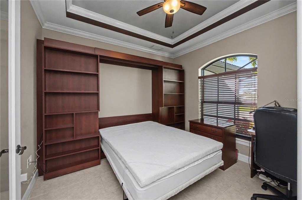 1736 Suzi Street Punta Gorda, FL 33950 - Photo 22 of 80 a bedroom with a bed and a chandelier