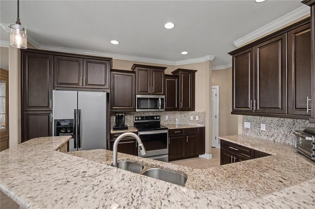 1736 Suzi Street Punta Gorda, FL 33950 - Photo 26 of 80 a kitchen with stainless steel appliances granite countertop a refrigerator sink and stove