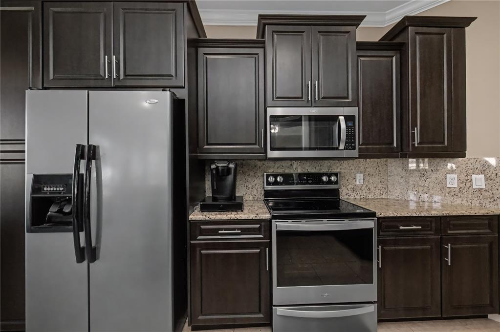 1736 Suzi Street Punta Gorda, FL 33950 - Photo 28 of 80 a kitchen with granite countertop stainless steel appliances and refrigerator