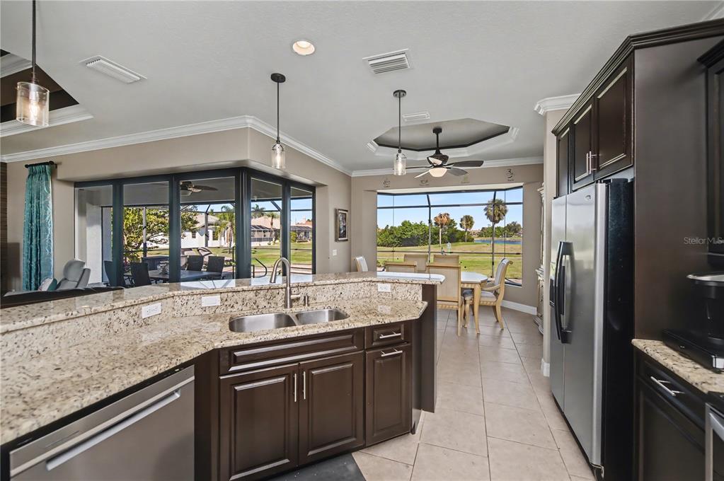 1736 Suzi Street Punta Gorda, FL 33950 - Photo 29 of 80 a kitchen with stainless steel appliances granite countertop a sink a stove and a refrigerator