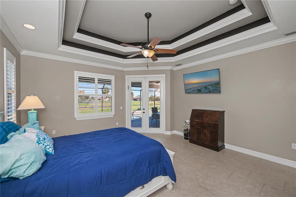 1736 Suzi Street Punta Gorda, FL 33950 - Photo 35 of 80 a bed room with a bed and a chandelier