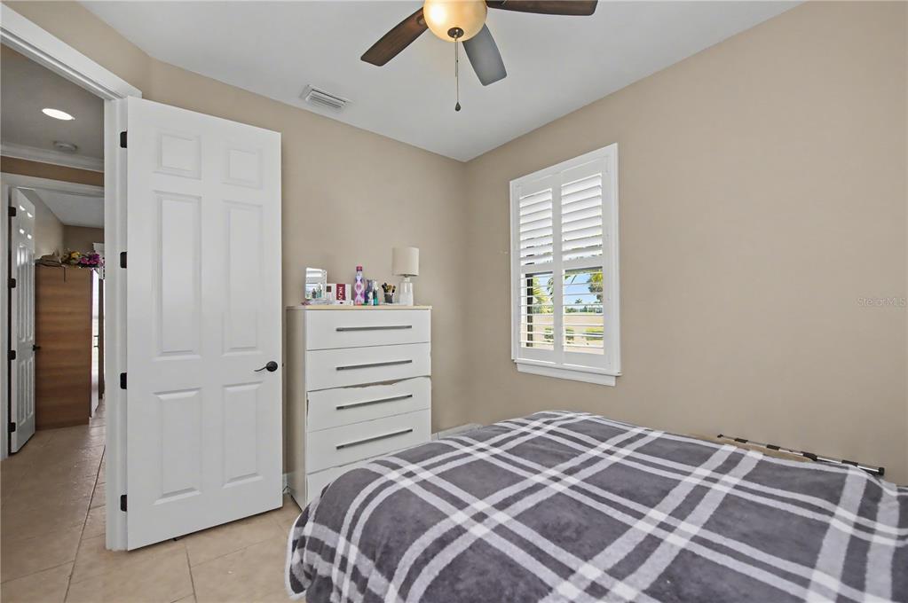 1736 Suzi Street Punta Gorda, FL 33950 - Photo 49 of 80 a bedroom with a bed and a chandelier
