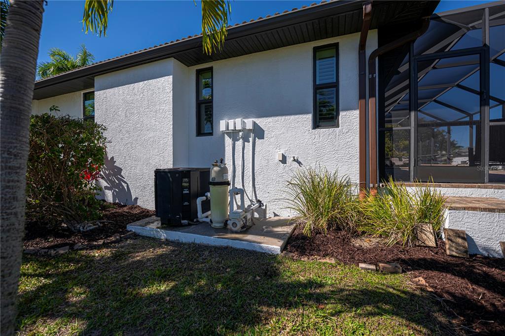 1736 Suzi Street Punta Gorda, FL 33950 - Photo 67 of 80 a potted plant sitting in front of a house