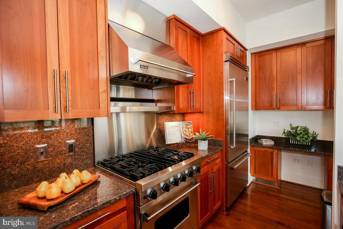 4301 Military Road Northwest, Unit 312 Washington, DC 20015 - Photo 5 of 9 a kitchen with stainless steel appliances granite countertop a stove and a refrigerator