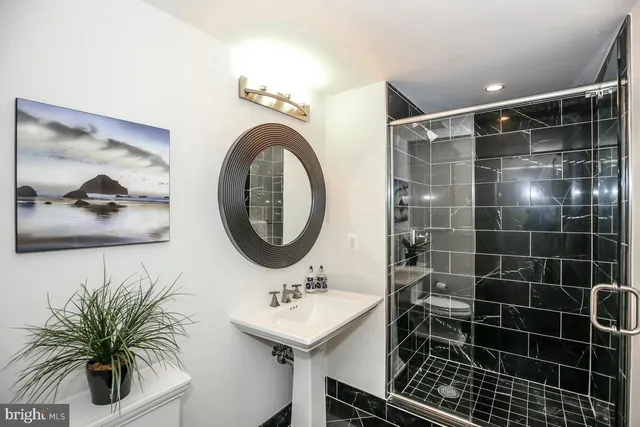 a bathroom with a sink a mirror and a shower