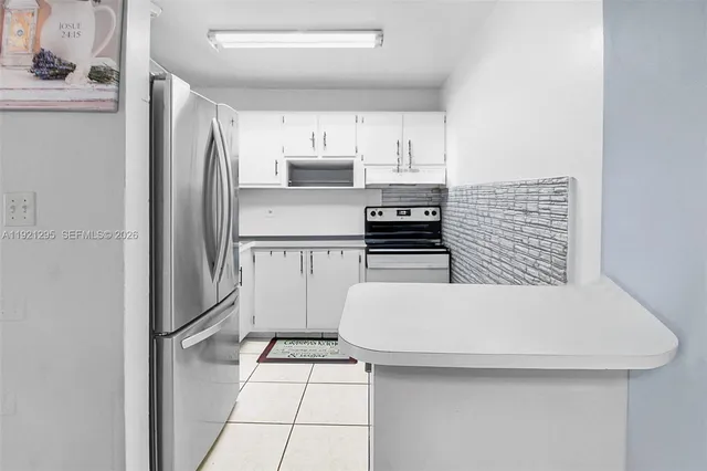 a kitchen with stainless steel appliances a refrigerator and a stove top oven