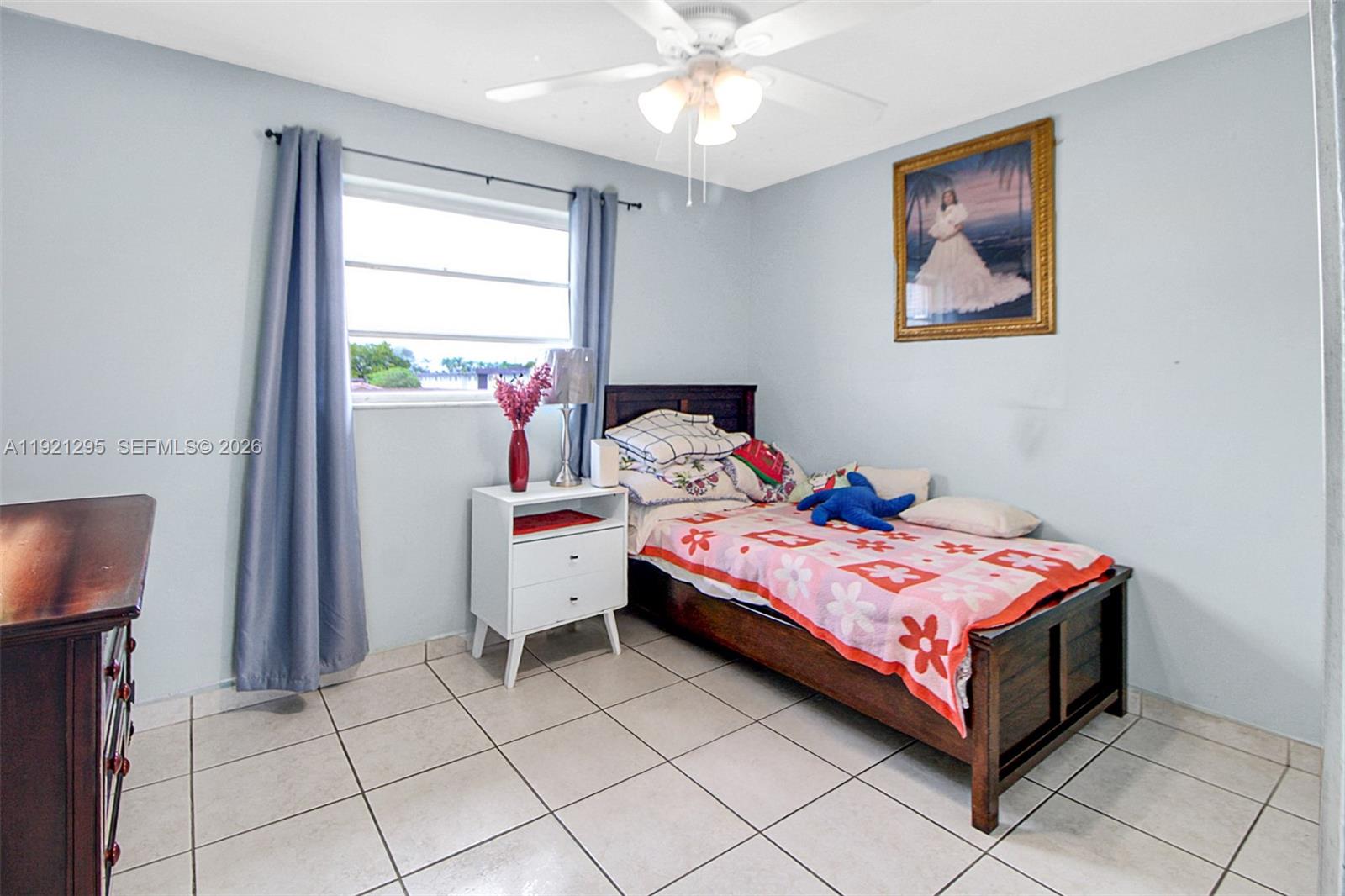 10745 Southwest 3rd Street, Unit 6 Sweetwater, FL 33174 - Photo 13 of 17 a bedroom with a bed and a window