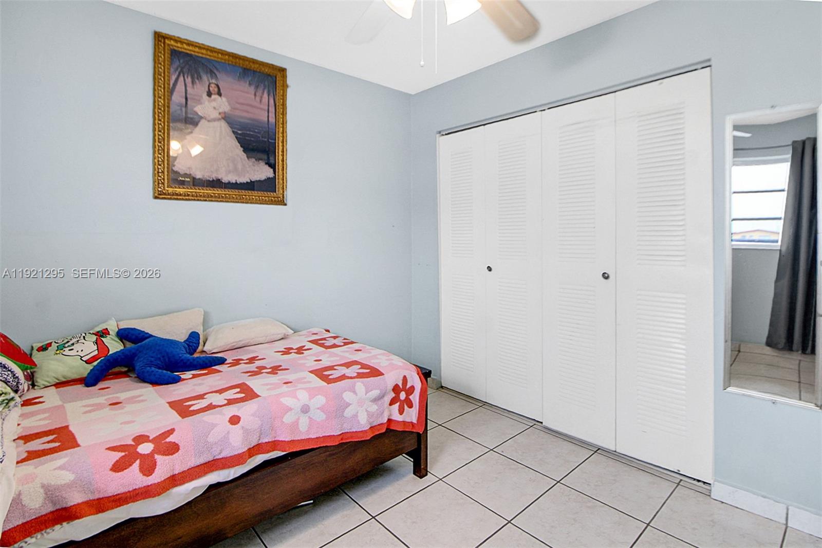 10745 Southwest 3rd Street, Unit 6 Sweetwater, FL 33174 - Photo 14 of 17 a bedroom with a bed and a window