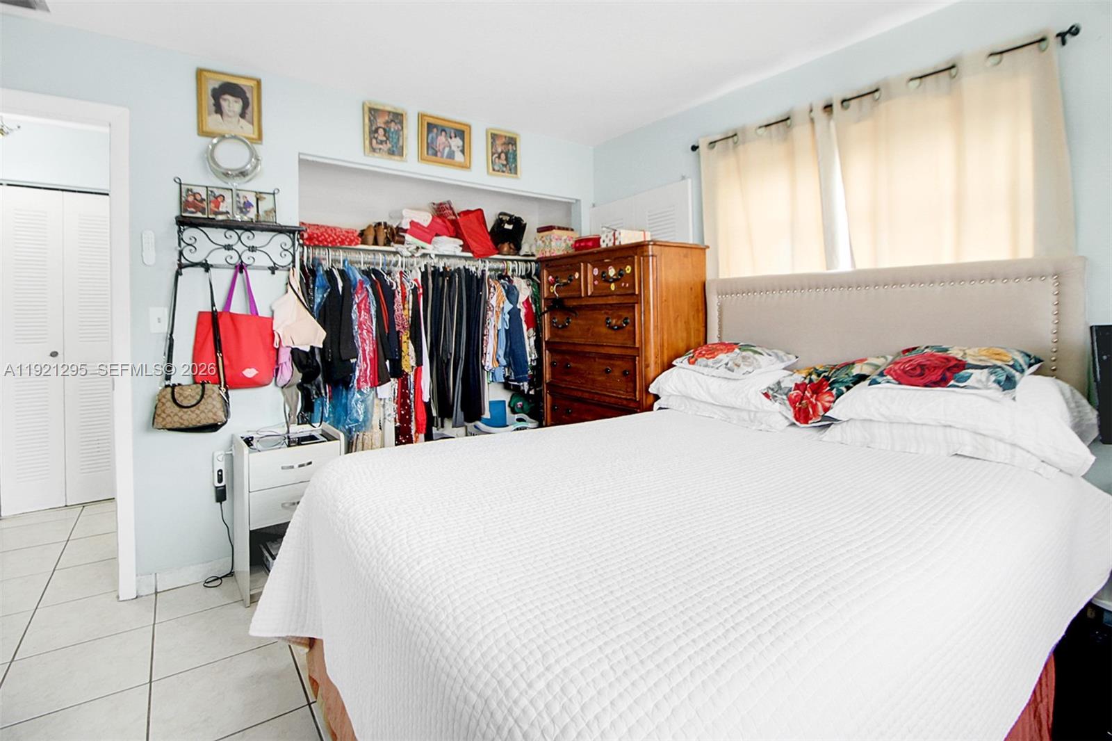 10745 Southwest 3rd Street, Unit 6 Sweetwater, FL 33174 - Photo 16 of 17 a bed room with a bed and a white kitchen