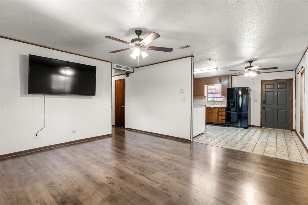 373 Ingred Street Waco, TX 76705 - Photo 4 of 39 a view of a livingroom with wooden floor and a flat screen tv