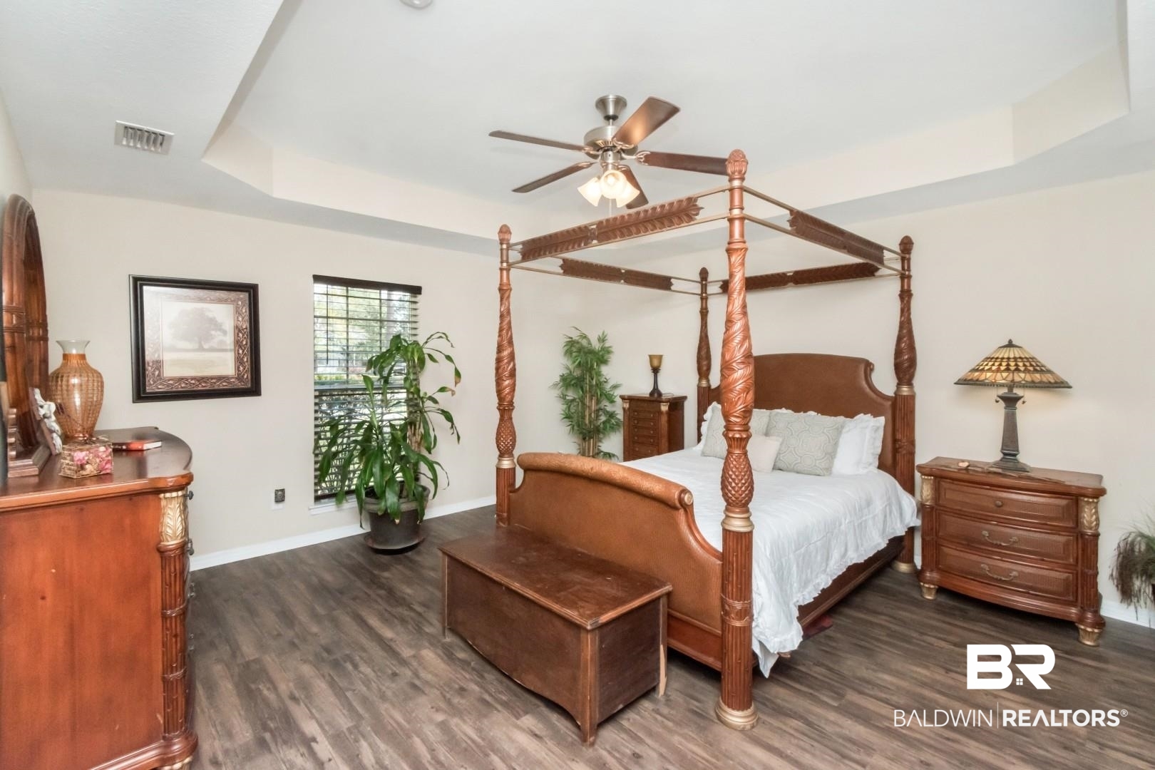 11528 Mocking Bird Lane Fairhope, AL 36532 - Photo 18 of 45 Bedroom featuring a raised ceiling, dark wood-style floors, and ceiling fan