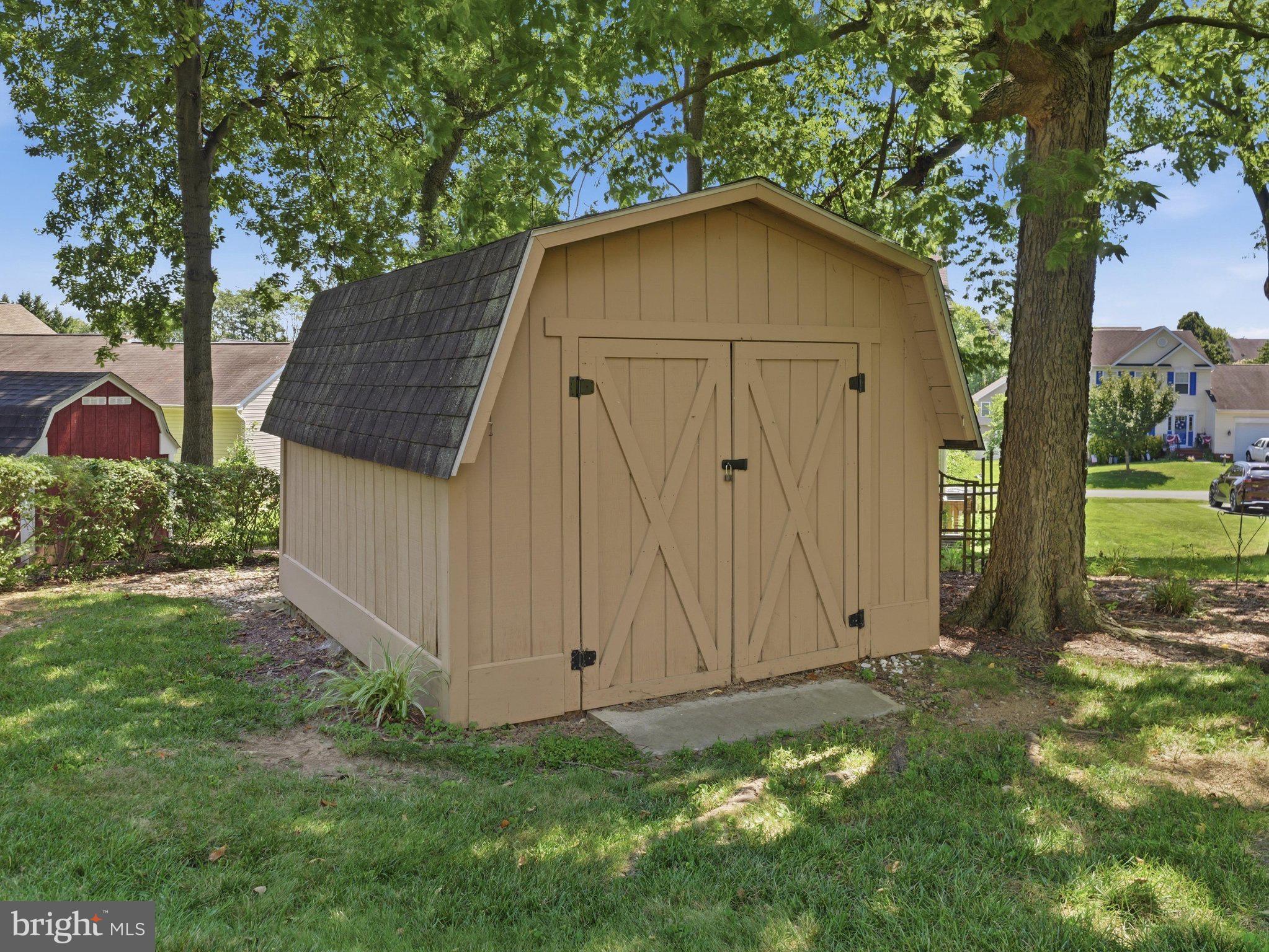 2606 Ridge Road South Martinsburg, WV 25403 - Photo 49 of 57 Charming shed nestled among lush greenery.