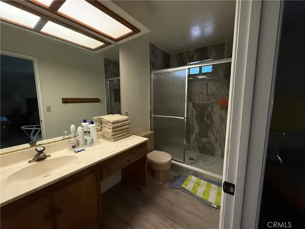 a bathroom with a double vanity sink toilet and shower
