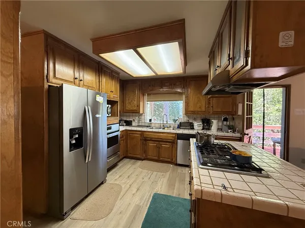 a kitchen with stainless steel appliances granite countertop a refrigerator and a stove