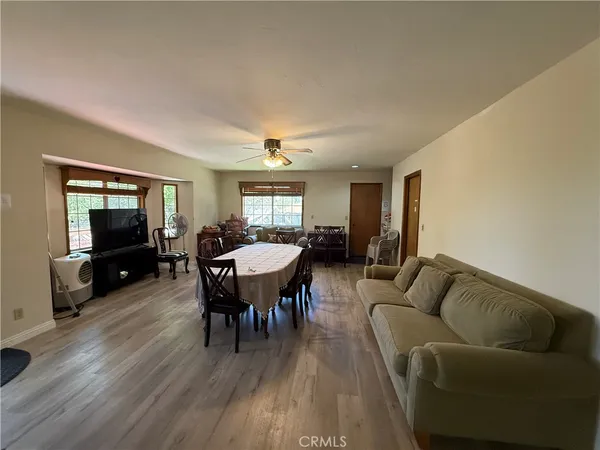 a living room with furniture a dining table and a flat screen tv