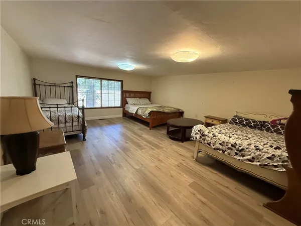 a bedroom with furniture and a wooden floor