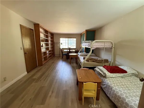 a bedroom with furniture and a wooden floor