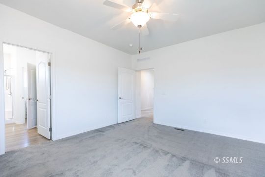 2014 South Brady Street Ridgecrest, CA 93555 - Photo 20 of 32 an empty room with a chandelier fan and closet area