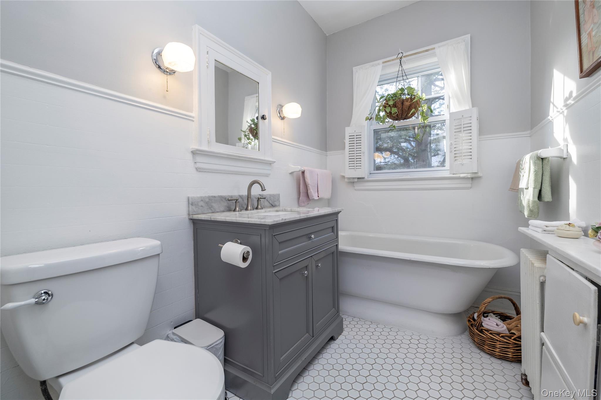 232 Sherman Street Lynbrook, NY 11563 - Photo 14 of 22 a bathroom with a toilet sink and mirror